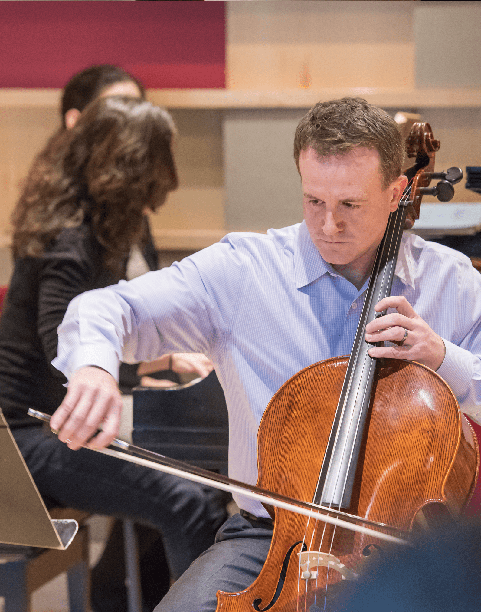 Adult musician playing the cello.