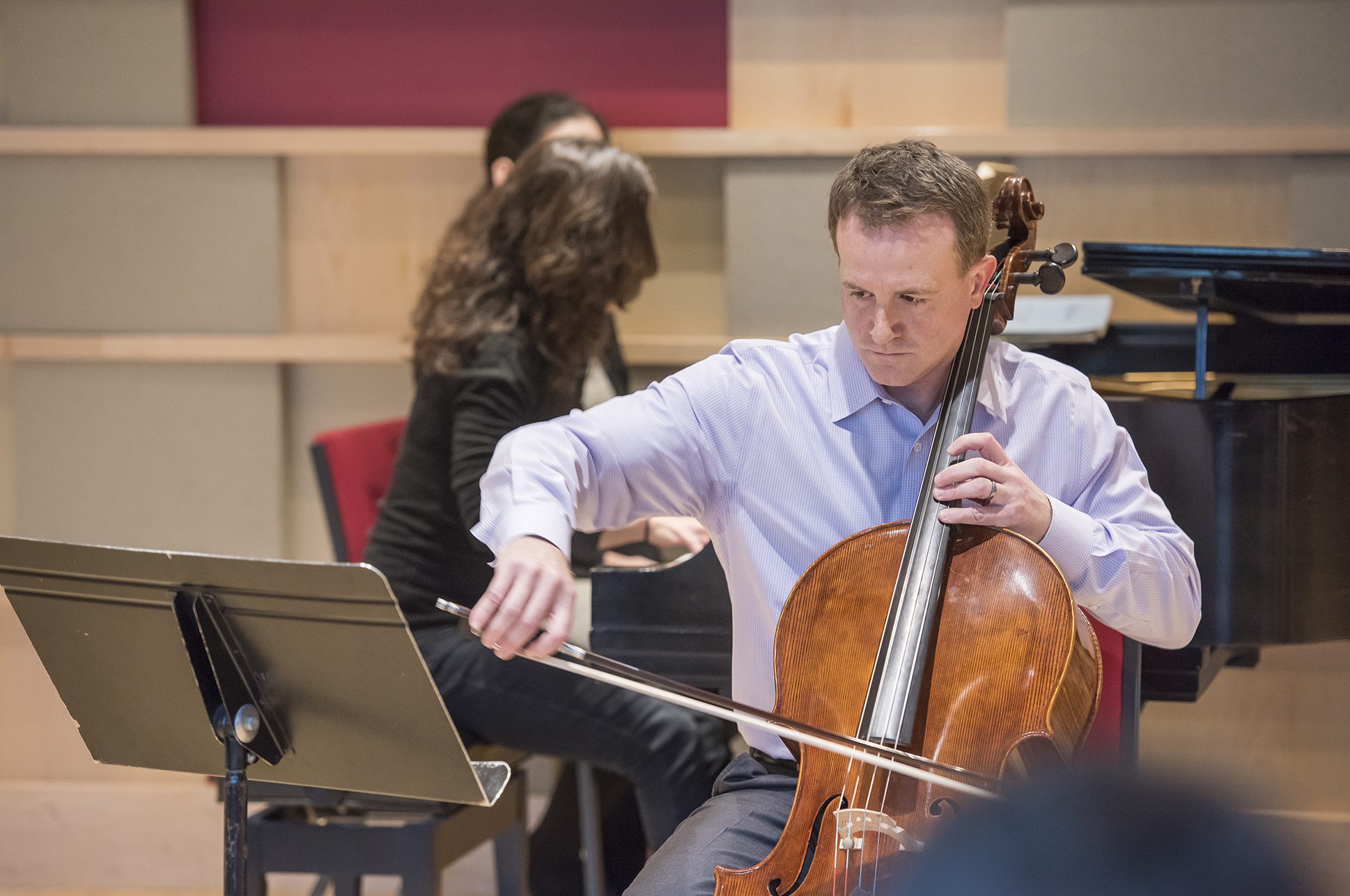 Adult musician playing the cello.