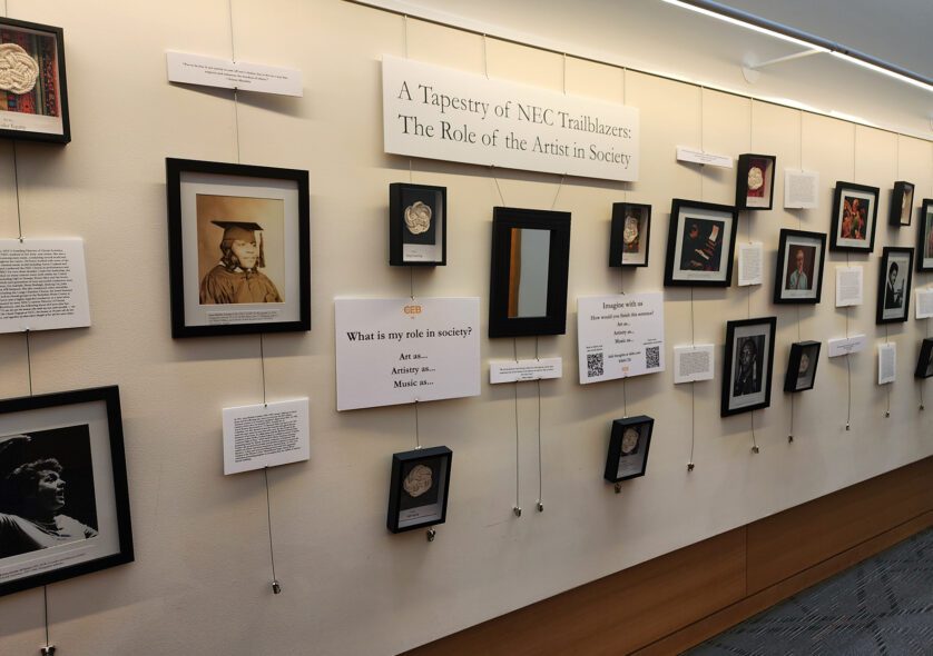 Tapestry of Trailblazers art installation at NEC, featuring framed images of inspirational members of the NEC community.