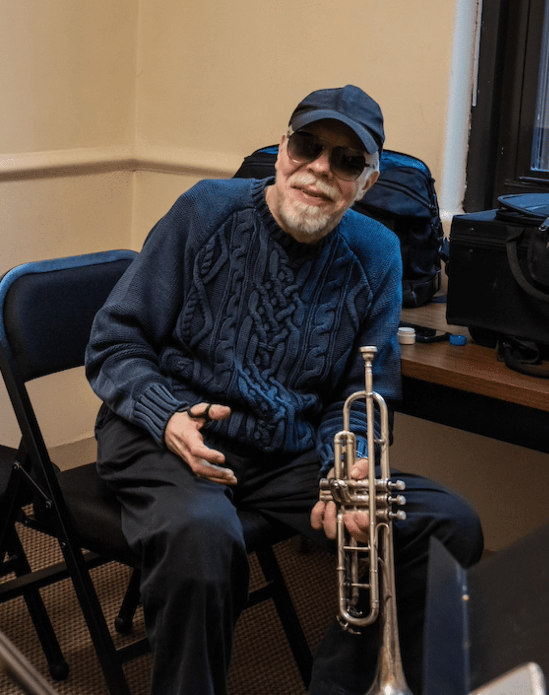 John McNeil holding a trumpet.