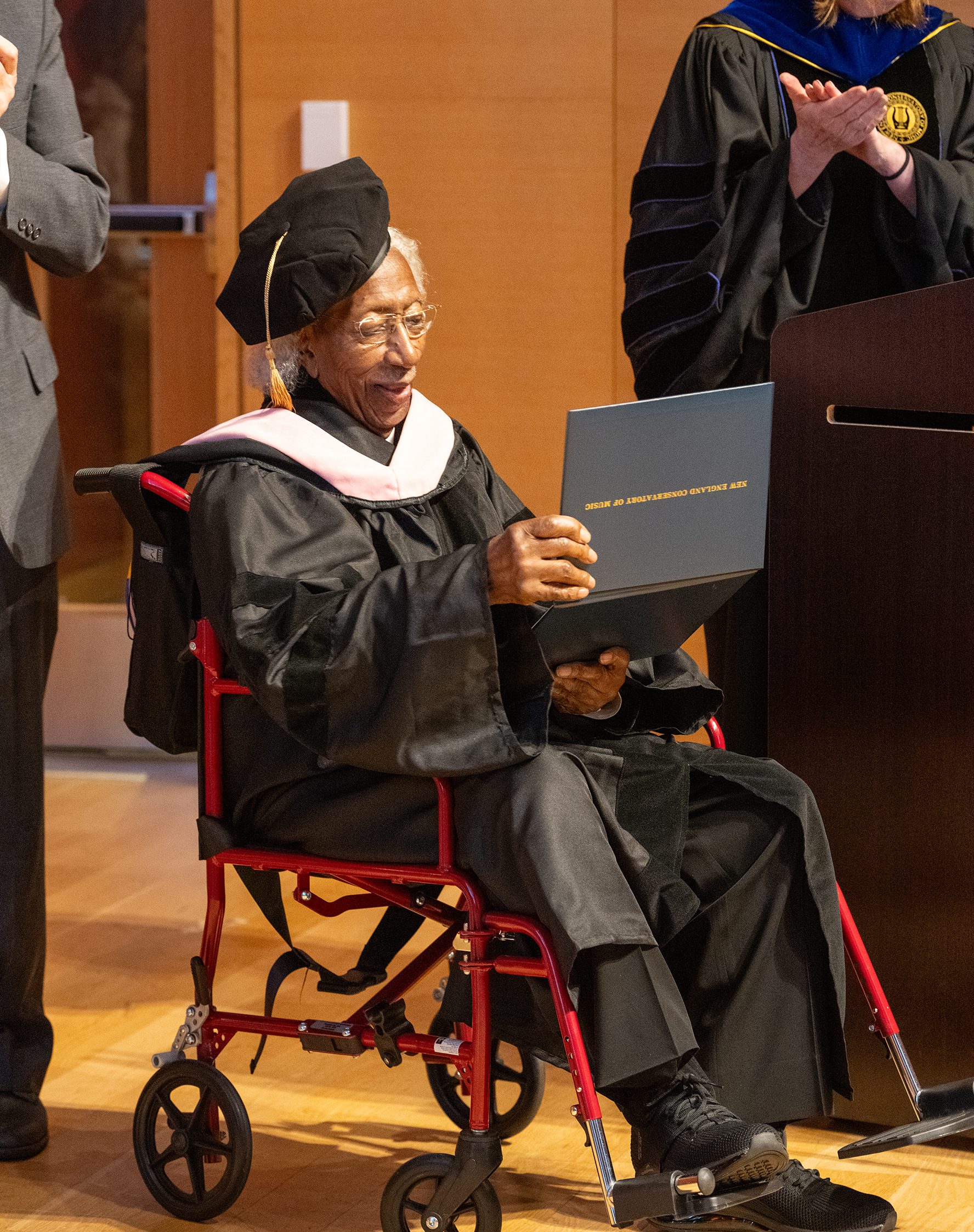 Marvin E. Gilmore, Jr. holding his honorary doctorate.