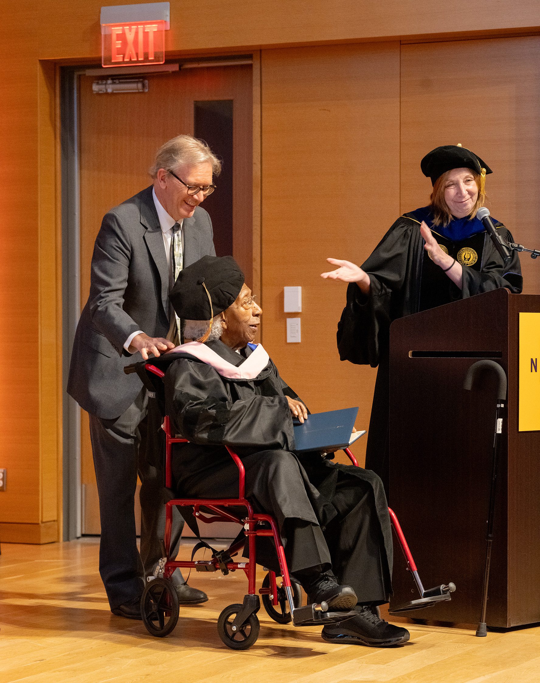 Ken Schaphorst hooding Marvin E. Gilmore, Jr. after NEC President Andrea Kalyn presented Marvin with his honorary doctorate.