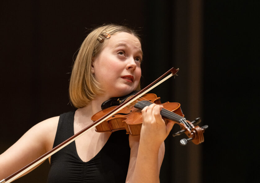 Closeup of a student playing violin.