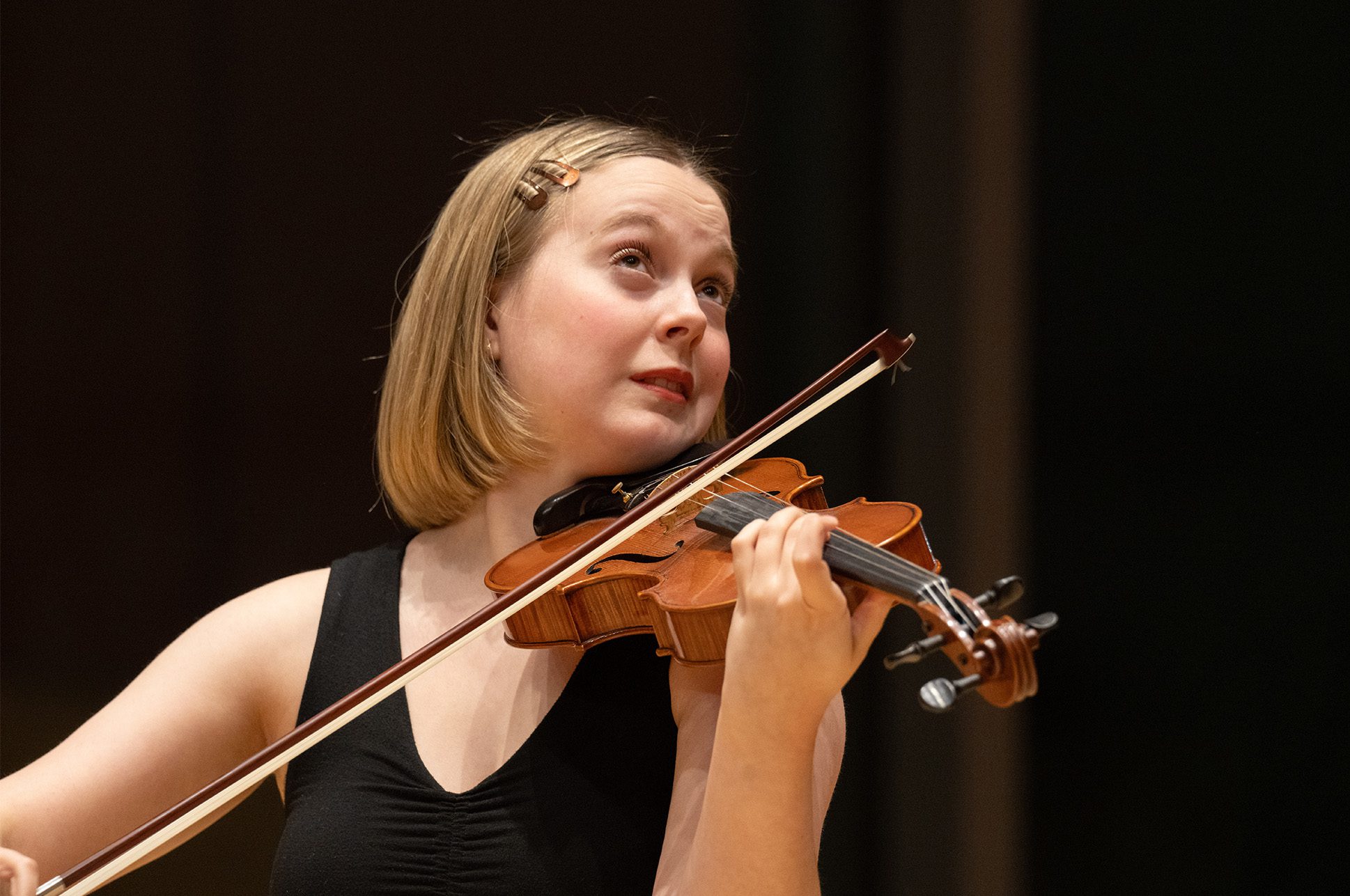 Closeup of a student playing violin.