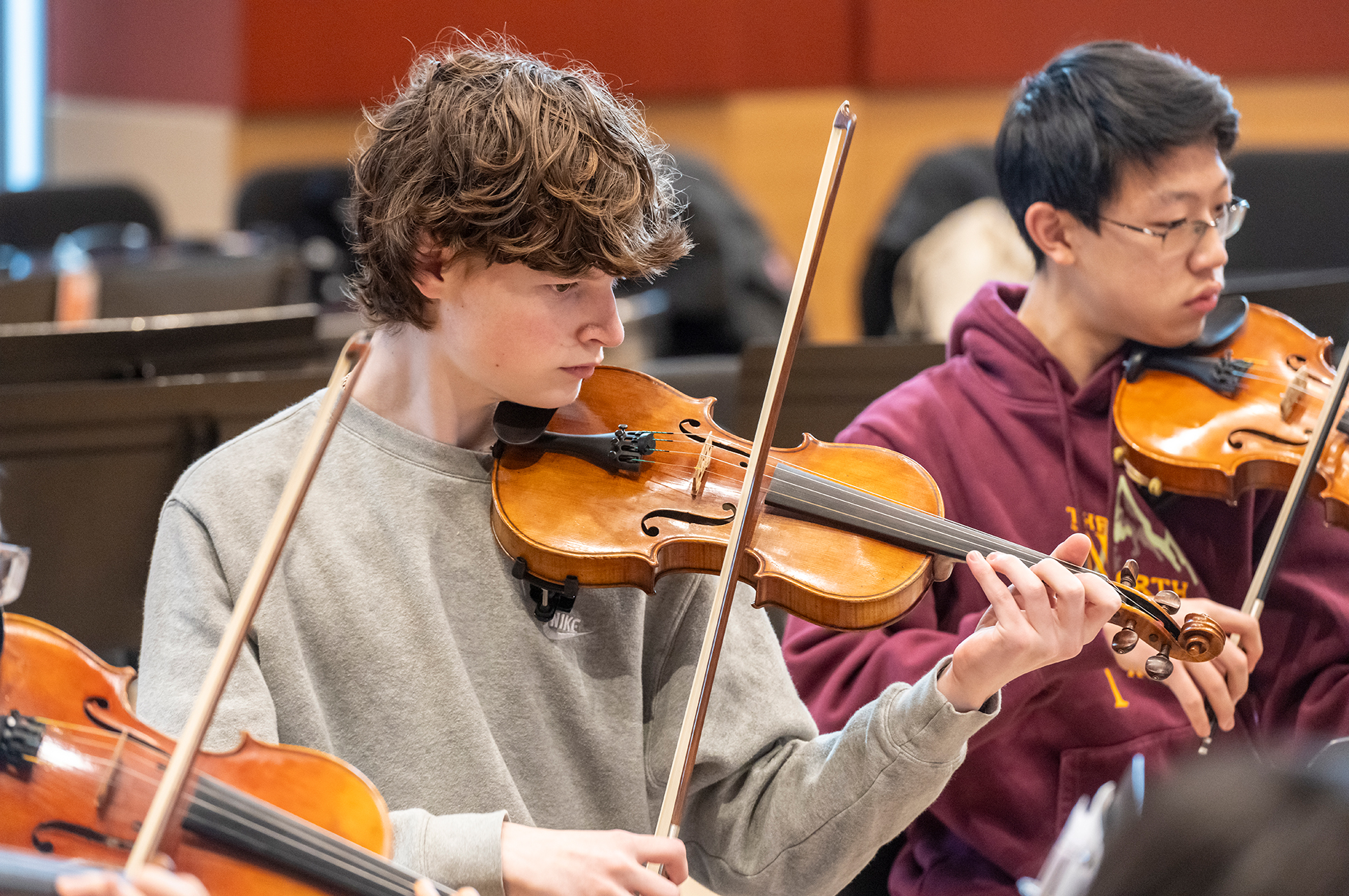 Students playing string instruments.