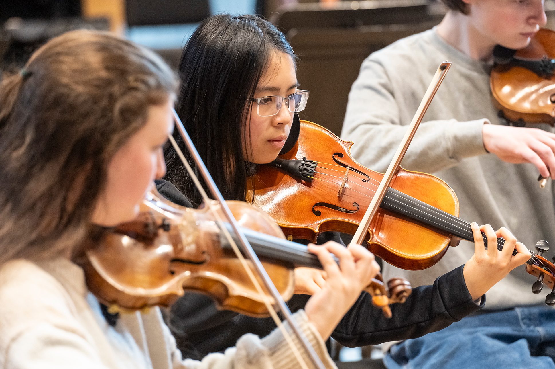 Students playing string instruments.