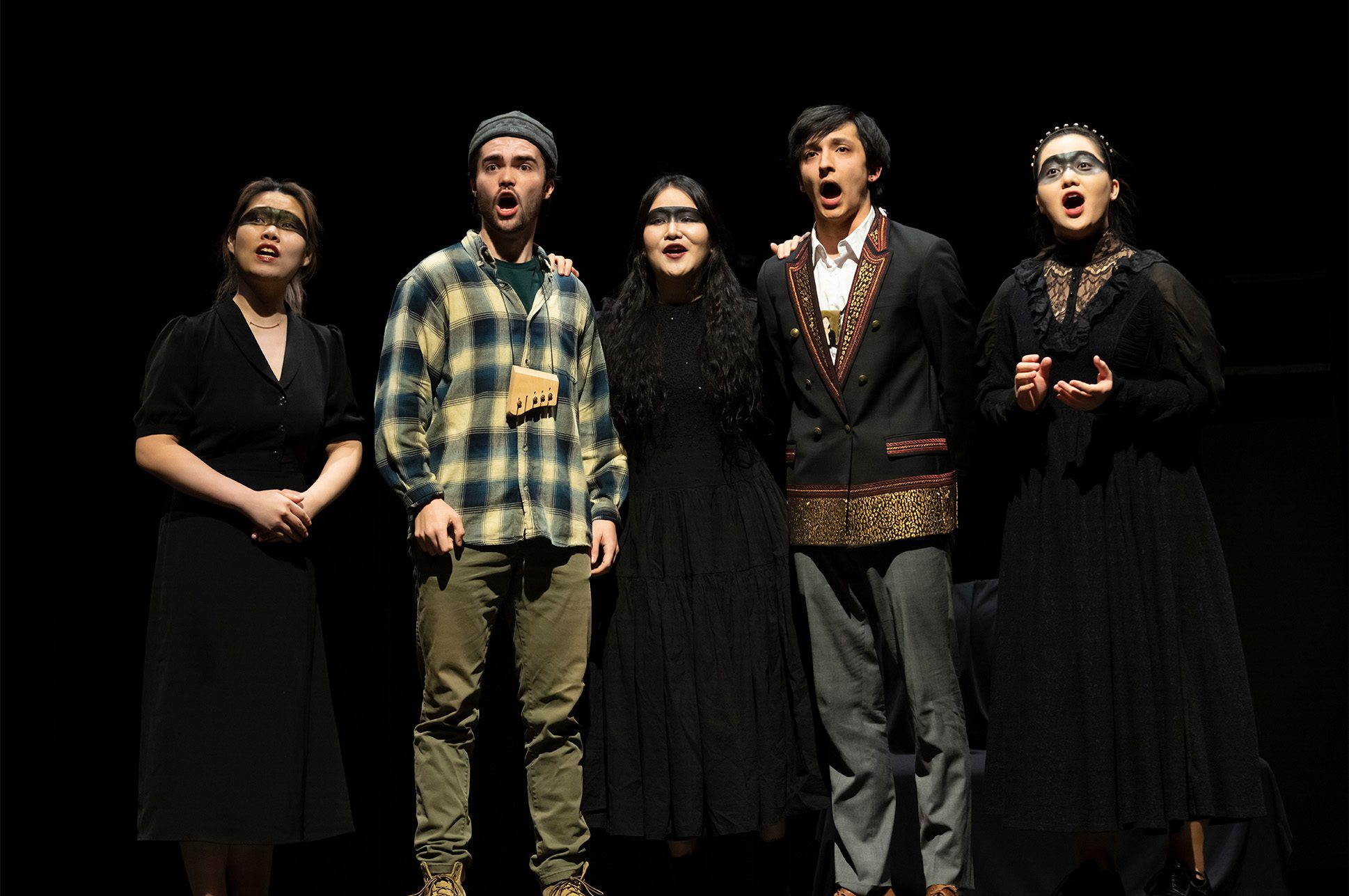 Five students performing opera on stage.