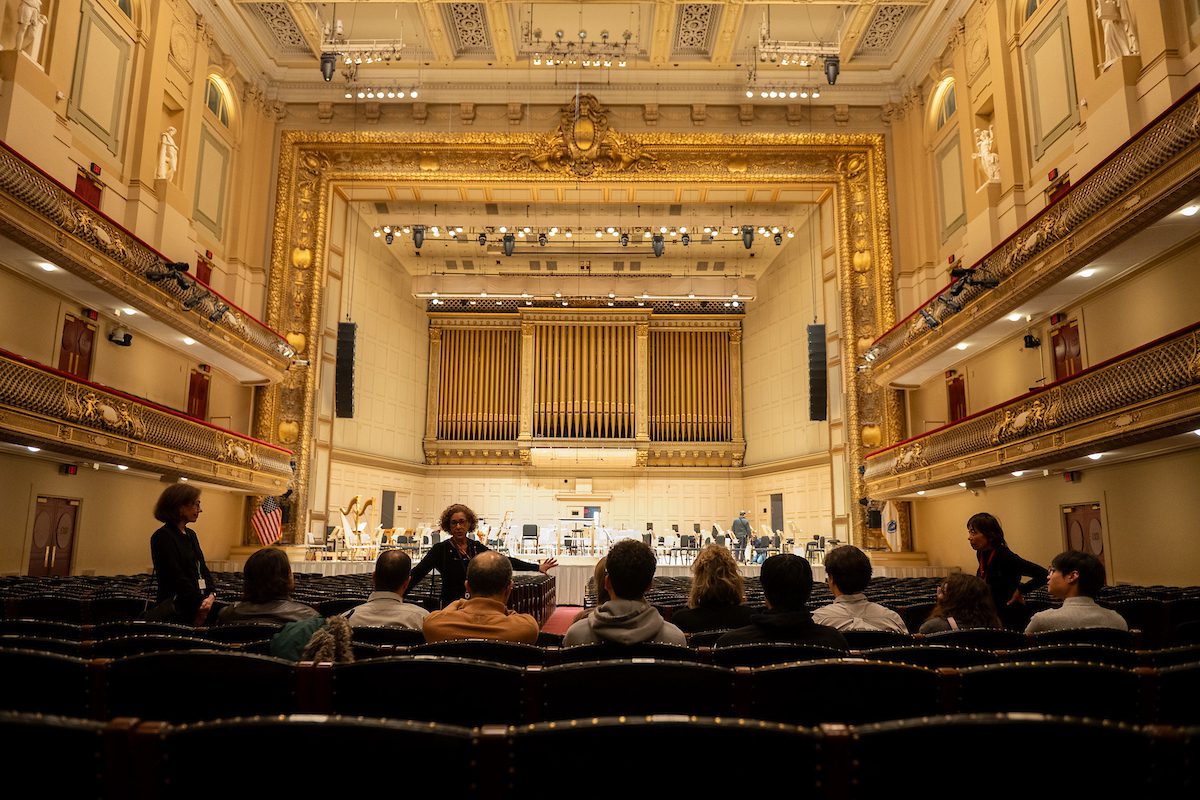 Visitors enjoy a behind-the-scenes tour of Symphony Hall, home of the renowned Boston Symphony Orchestra.