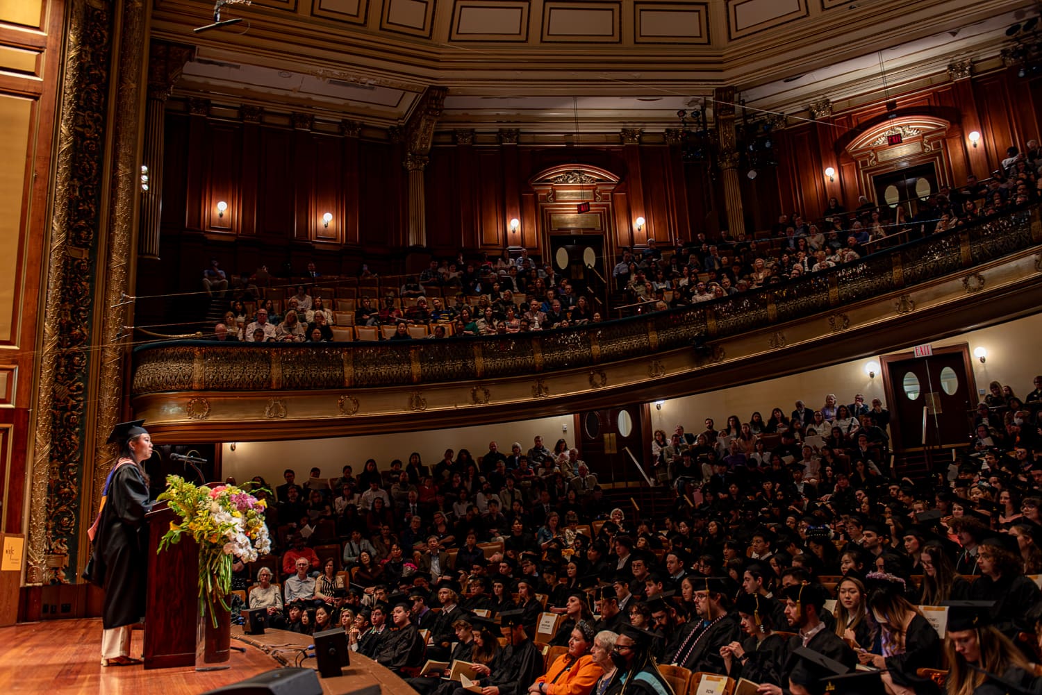 240519_NEC_078 Student speaking to a crowd in Jordan Hall during commencement.