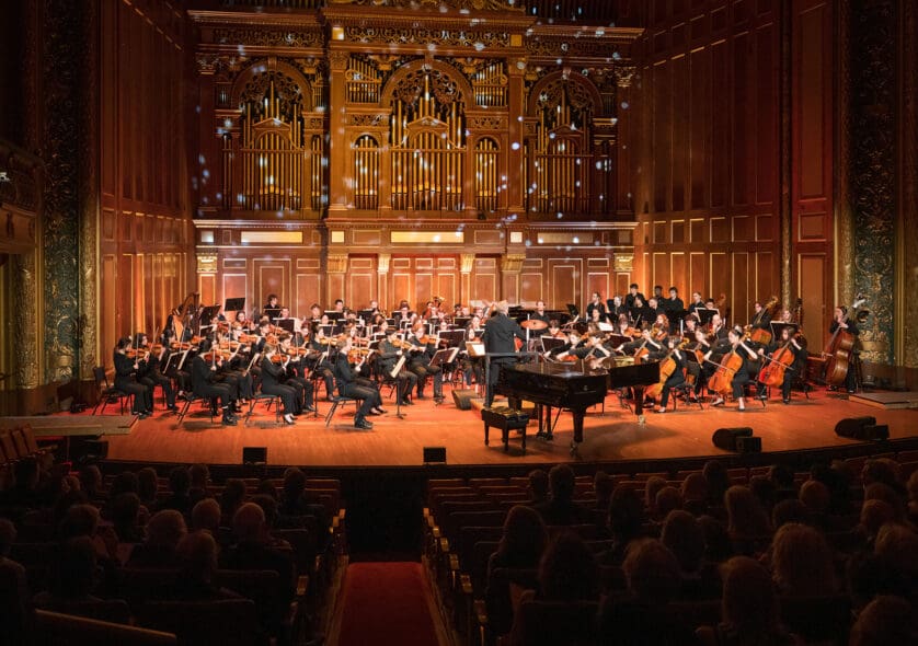 An orchestra performing in Jordan Hall.