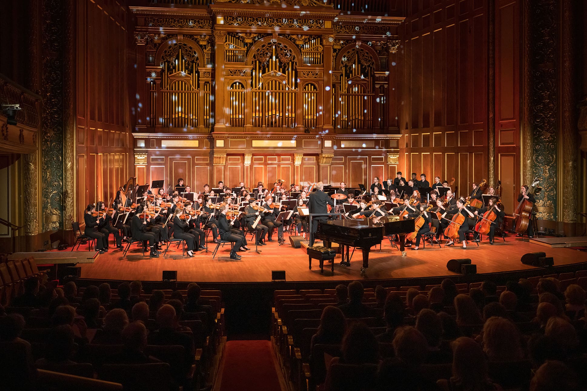 An orchestra performing in Jordan Hall.