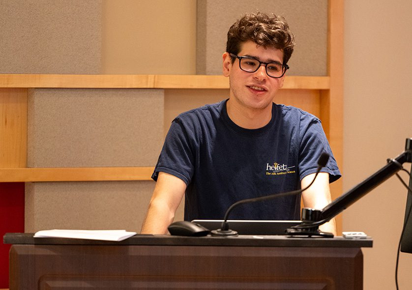 A student presenting at a podium.