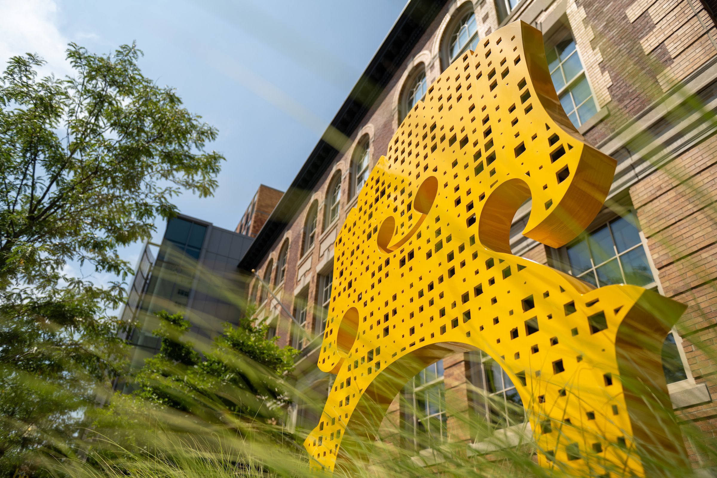 Exterior photo of a sculpture outside of an NEC building.