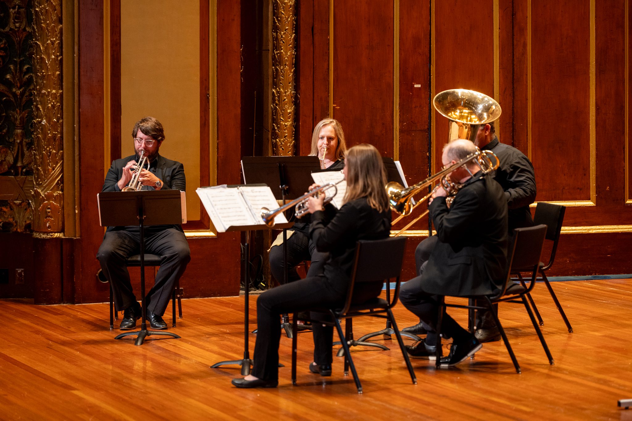 Trumpeters Ryan Noe and Elizabeth Jewell, horn player Lauren Winter, trombonist Brian Diehl, and tubist Eric Goode perform in Jordan Hall.