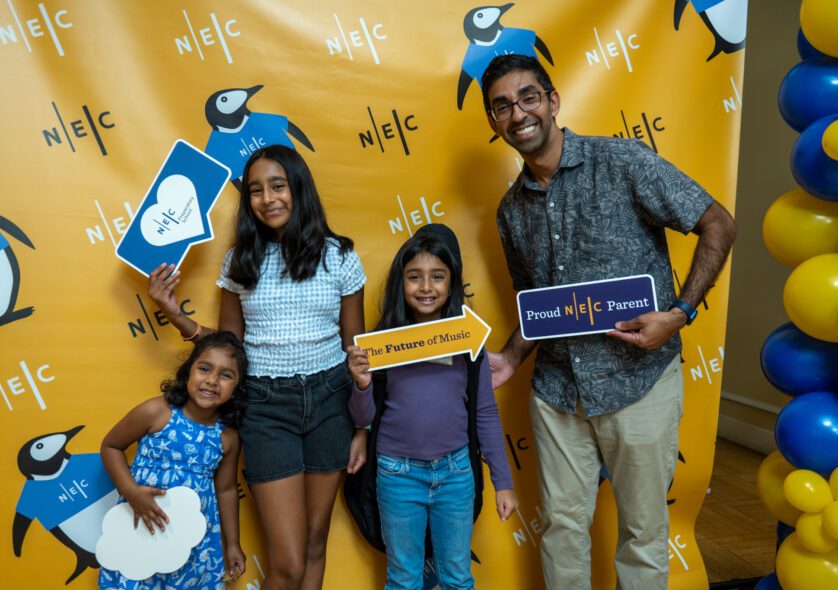 A family poses has fun posing for a photograph at the Welcome Fair.