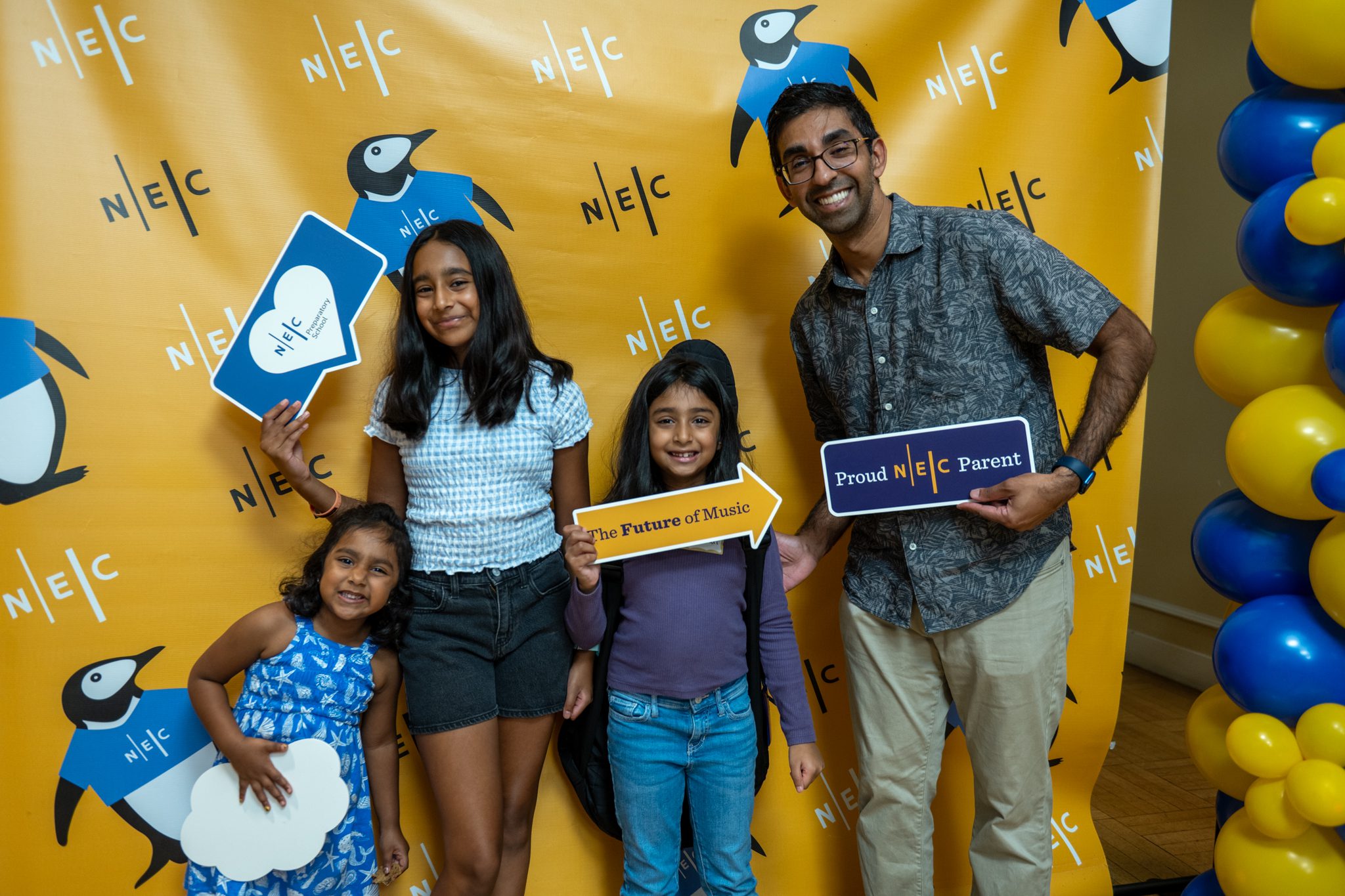 A family poses has fun posing for a photograph at the Welcome Fair.