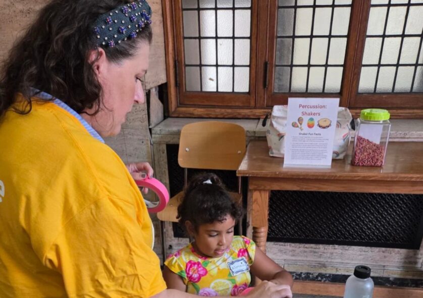 Katherine Drago Luellen, NEC’s chief growth officer, joins a student in the Musical Playground, which was hosted by the Expanded Education Department's Director of Early Childhood Education Vanessa Trien.