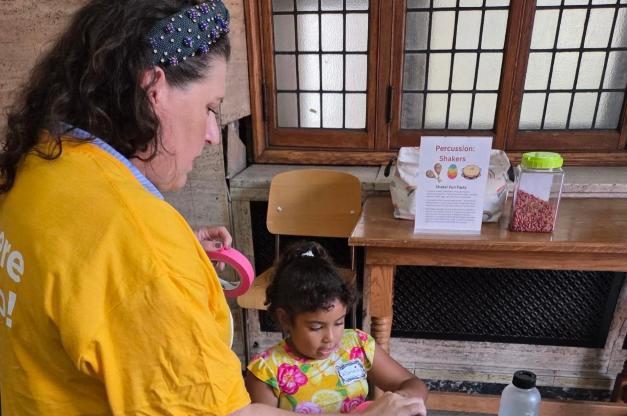 Katherine Drago Luellen, NEC’s chief growth officer, joins a student in the Musical Playground, which was hosted by the Expanded Education Department's Director of Early Childhood Education Vanessa Trien.