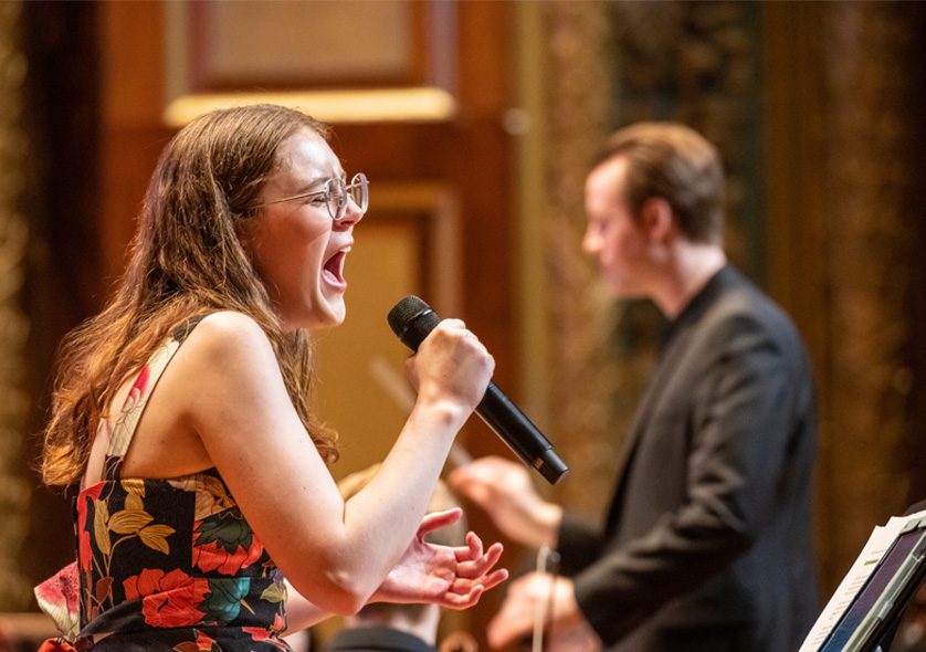 Student singing into a microphone.