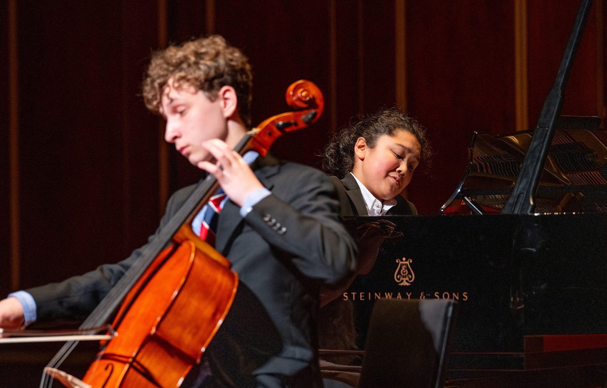 Two NEC Prep students playing cello and piano on stage.