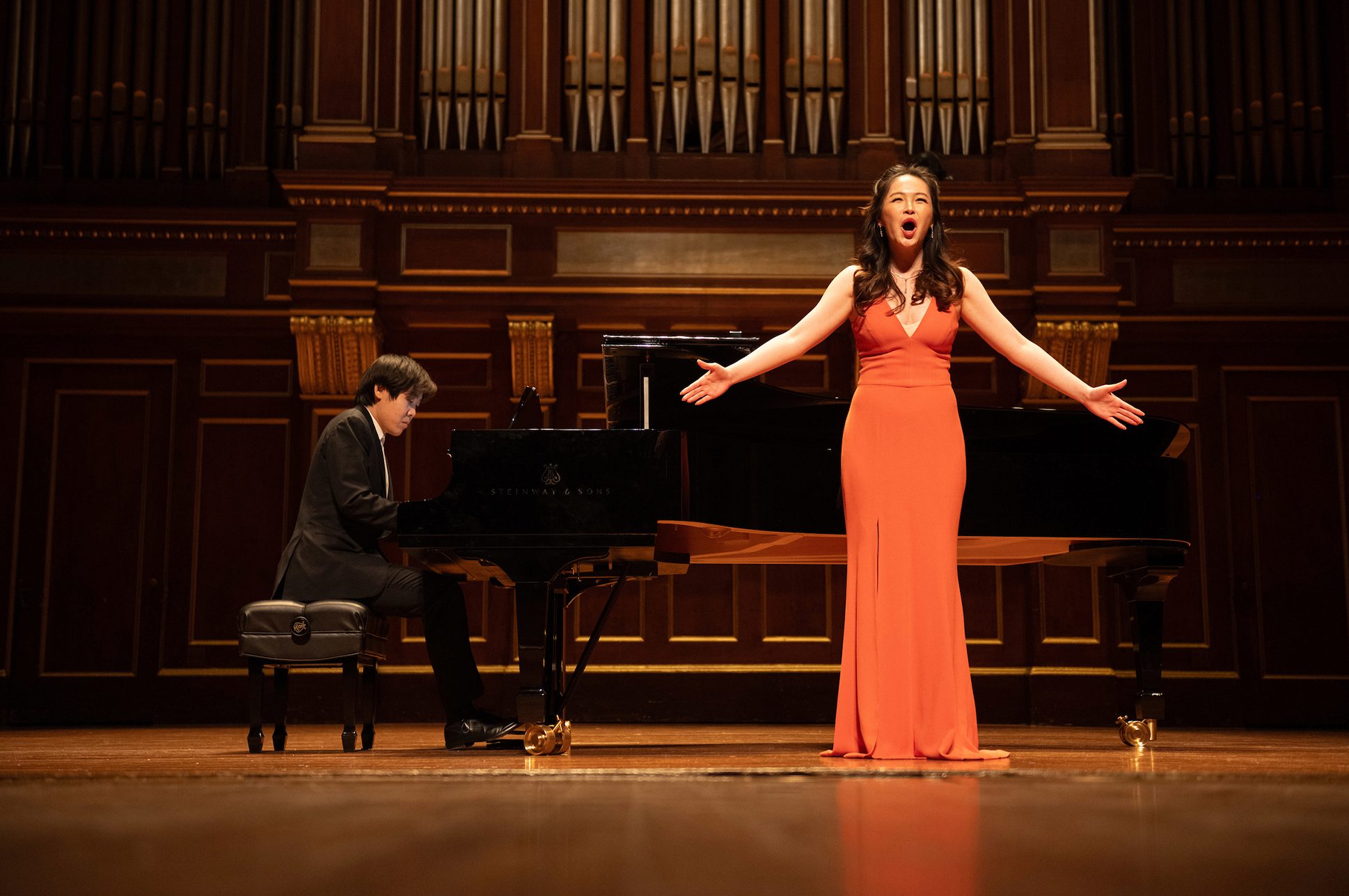 Pianist Yutong Sun and soprano Dani Jingdan Zhang performing together on the Jordan Hall Stage.