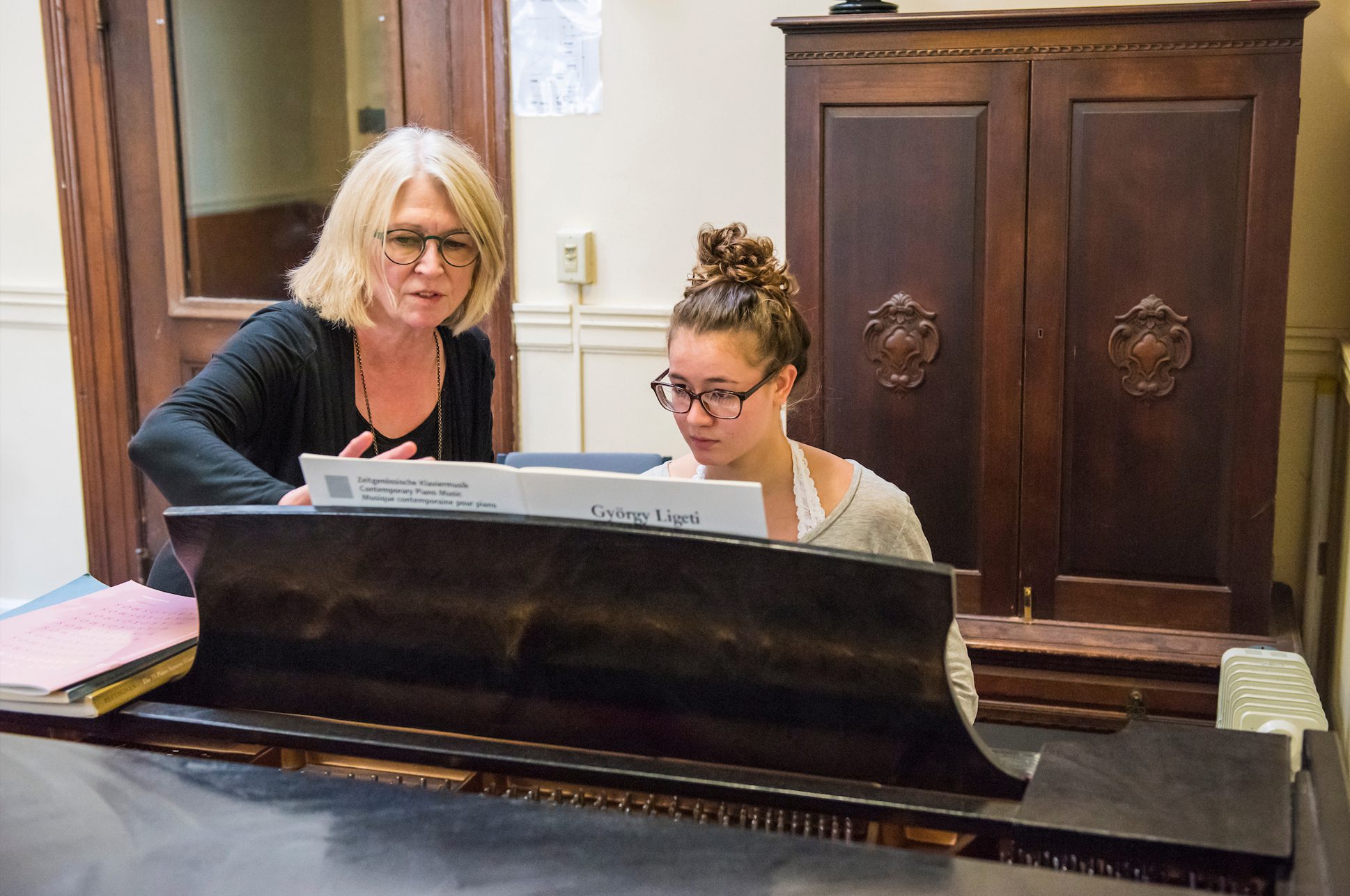 A student receiving a piano lesson.