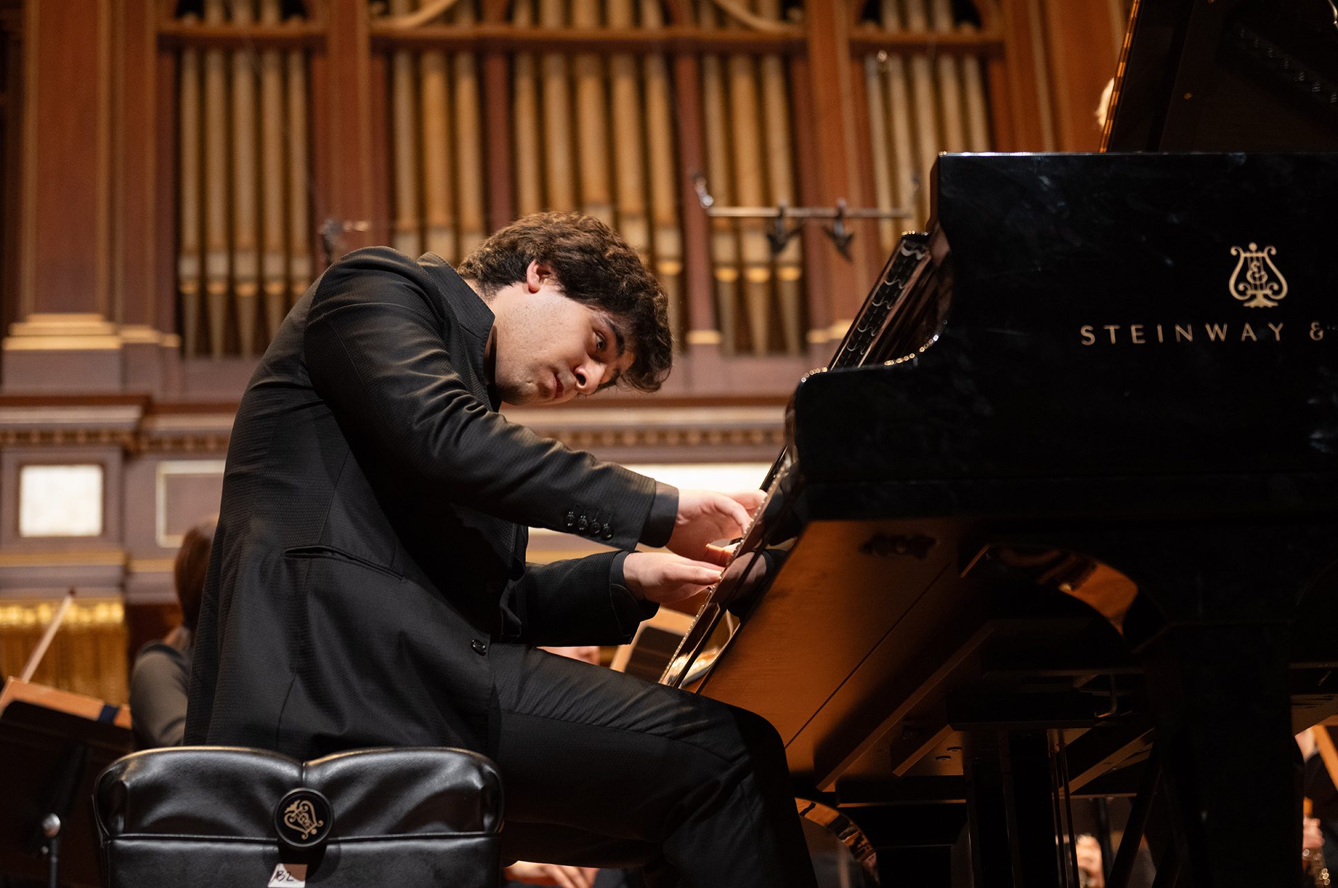 Evren Ozel playing the piano on the Jordan Hall stage. Evren Ozel playing the piano on the Jordan Hall stage.