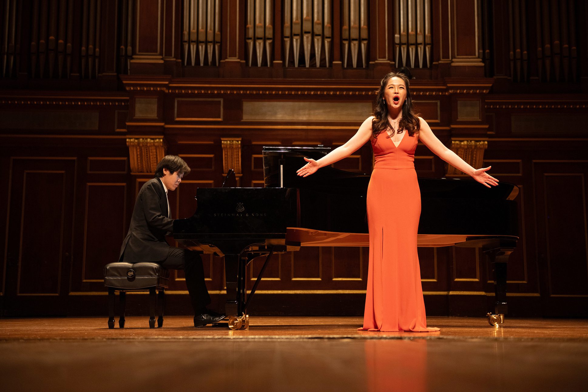 Pianist Yutong Sun and soprano Dani Jingdan Zhang performing together on the Jordan Hall Stage. Pianist Yutong Sun and soprano Dani Jingdan Zhang performing together on the Jordan Hall Stage.
