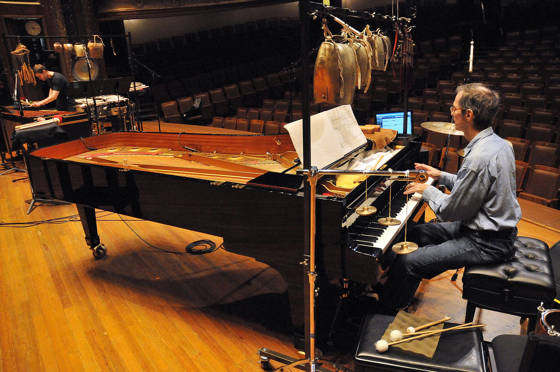 Person playing a piano in an avant garde performance. Person playing a piano in an avant garde performance.
