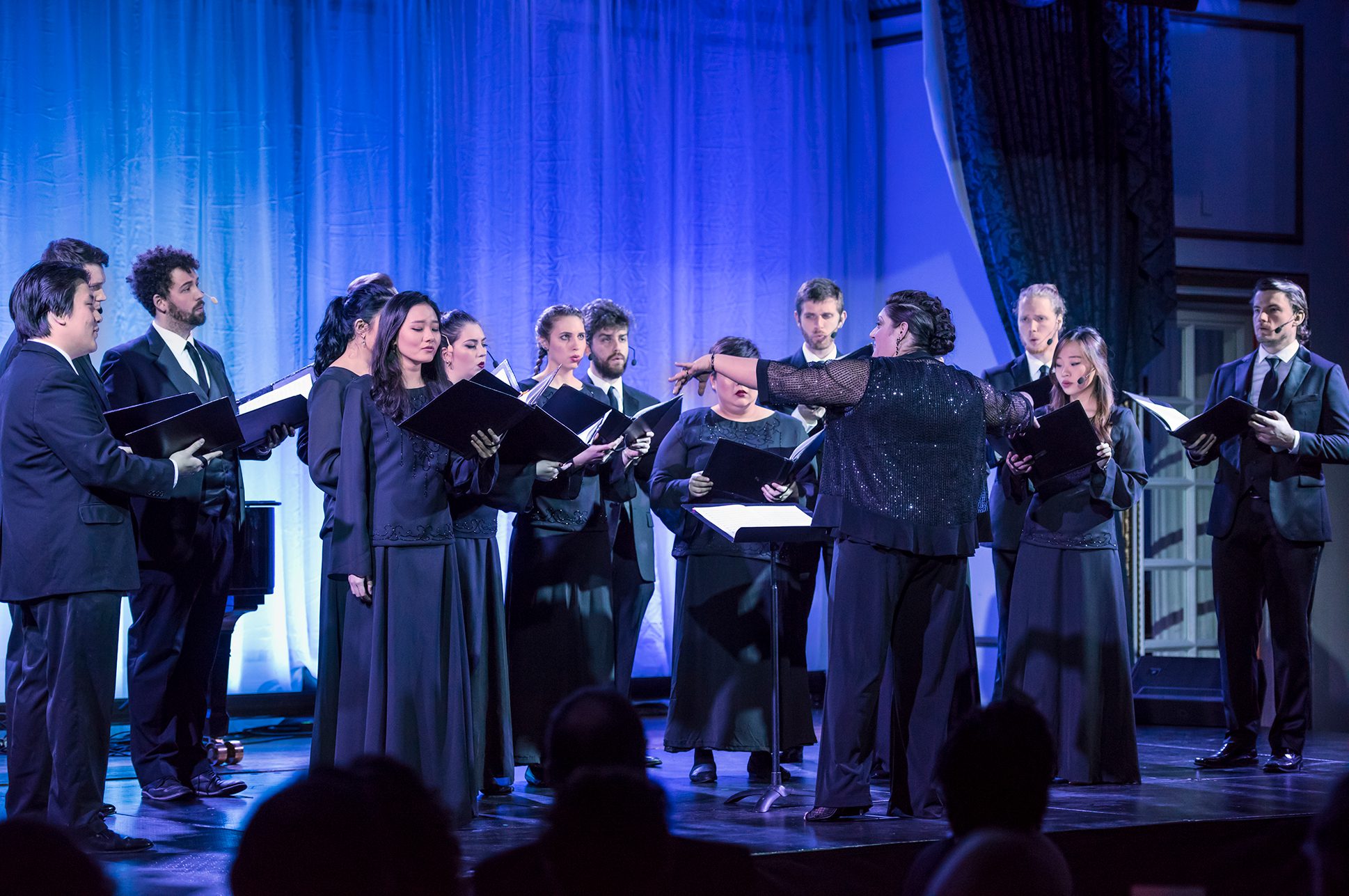 A chorus of singers led by conductor Erica Washburn. A chorus of singers led by conductor Erica Washburn.