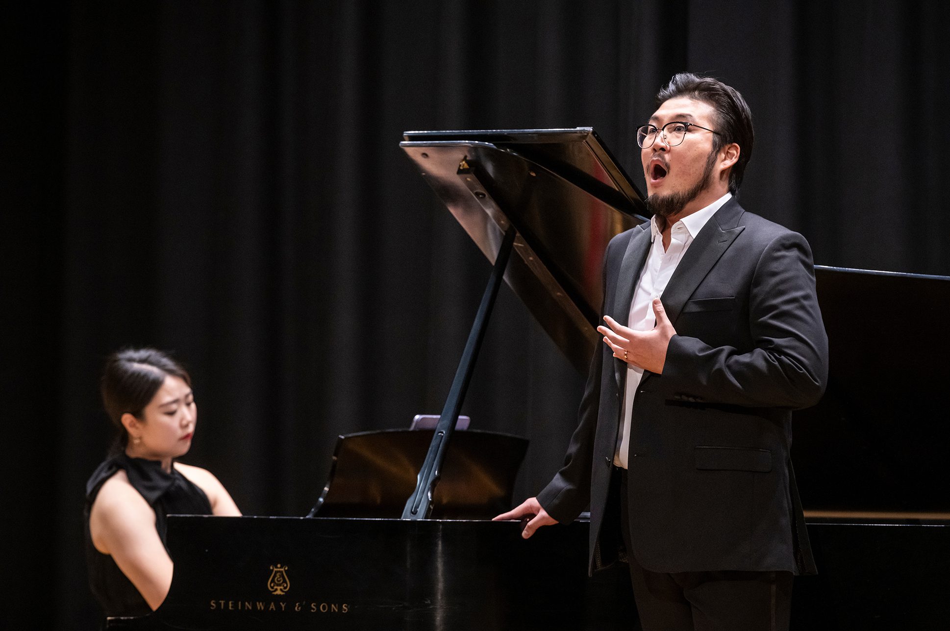 Baritone Hyungjin Son and pianist Sujin Choi performing on stage in Williams Hall at NEC.