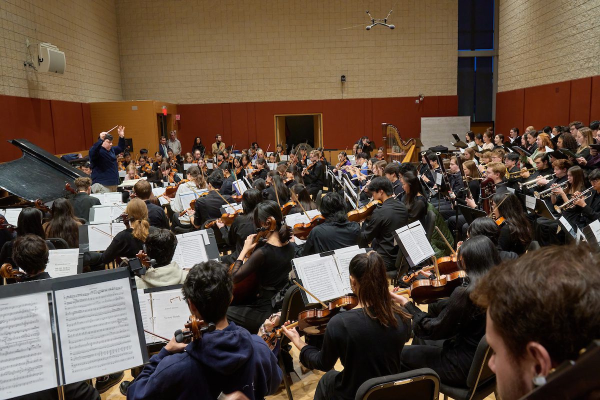 Juliano Aniceto leads the Youth Philharmonic Orchestra in a rehearsal in Burnes Hall.