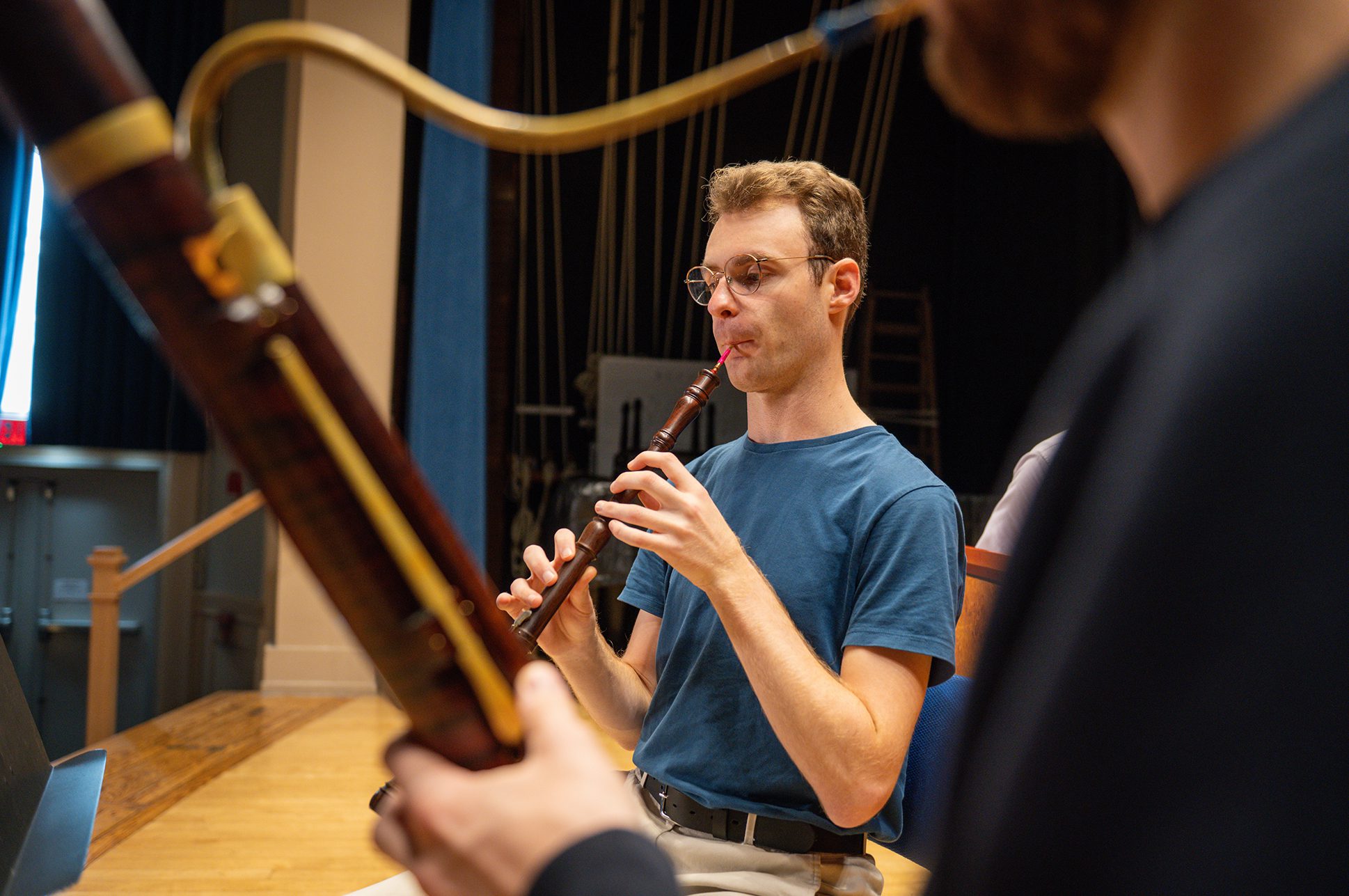 Two students playing Baroque-era wind instruments.