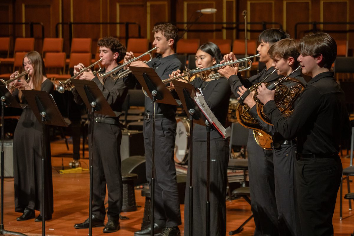 Brass players and percussionists from the Senior Massachusetts Youth Ensemble perform the premiere of Ruhan Iyer's "Fanfare for an Unparalleled Preparatory School."