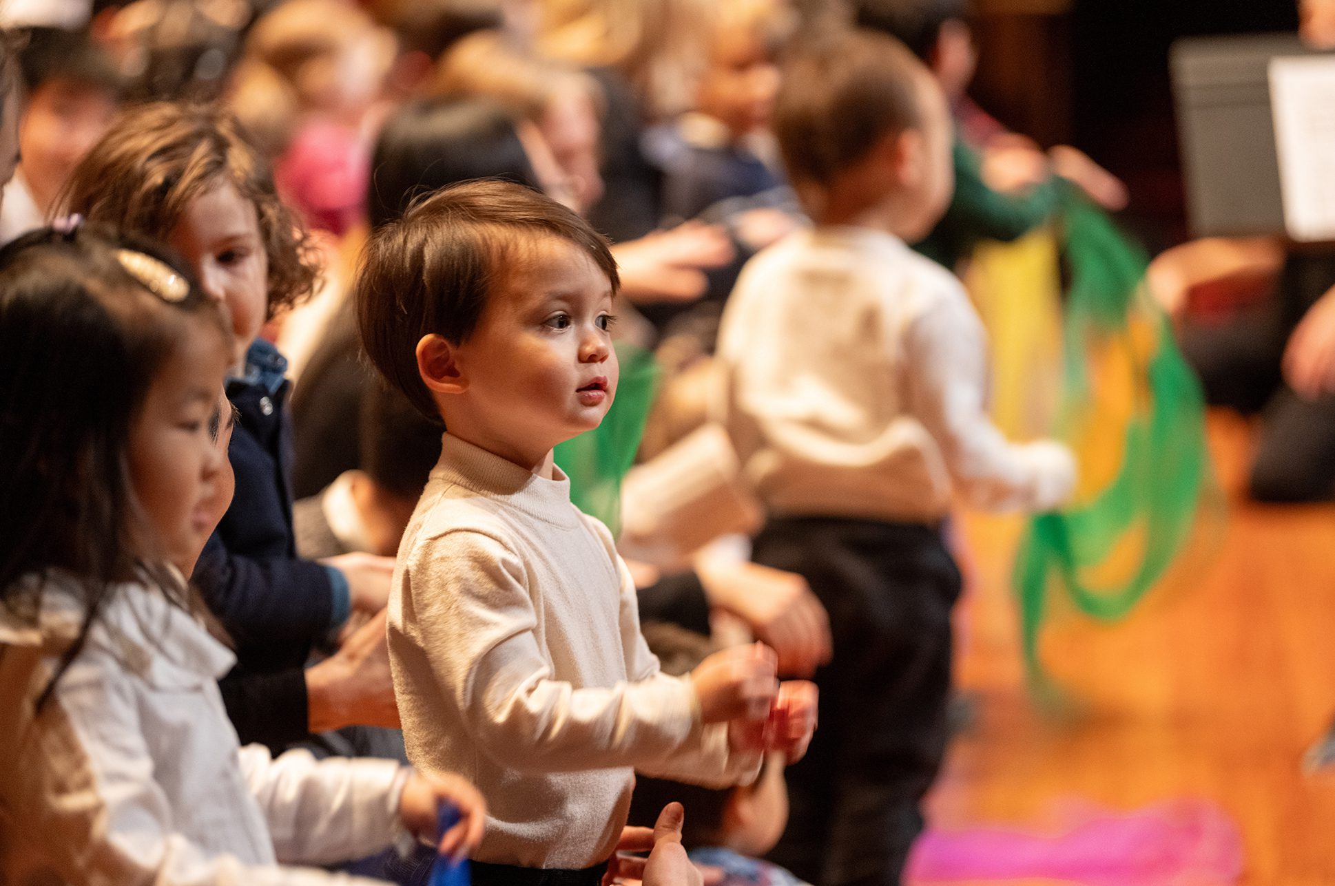A group of toddlers participating in an early childhood music program.