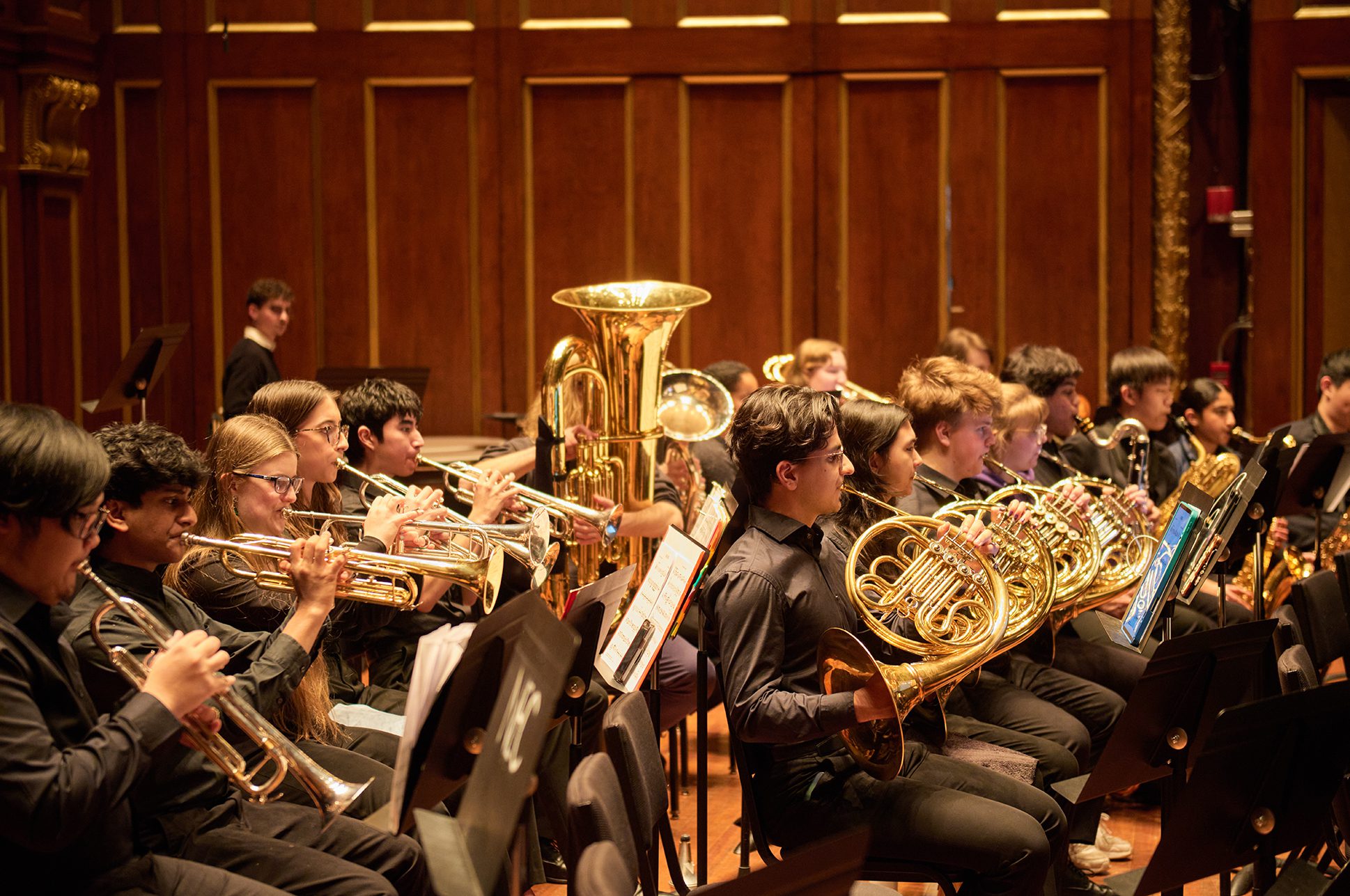 Young brass musicians in an orchestra on stage. Young brass musicians in an orchestra on stage.