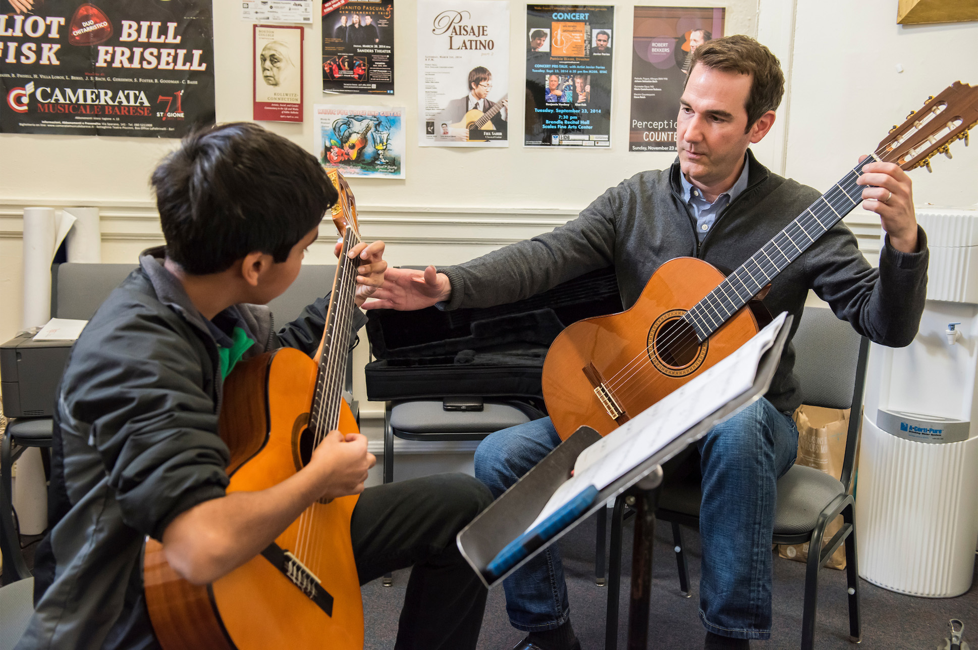 Prep_Certificates A guitar teacher and a student during a lesson.