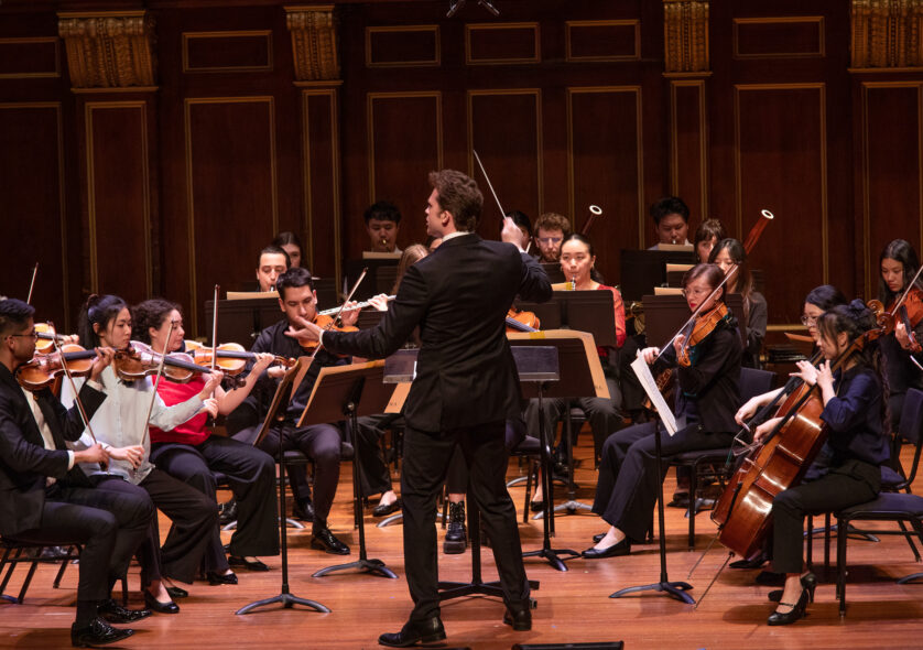 Clancy Ellis '26 GD leads a performance of the Overture to Mozart's 