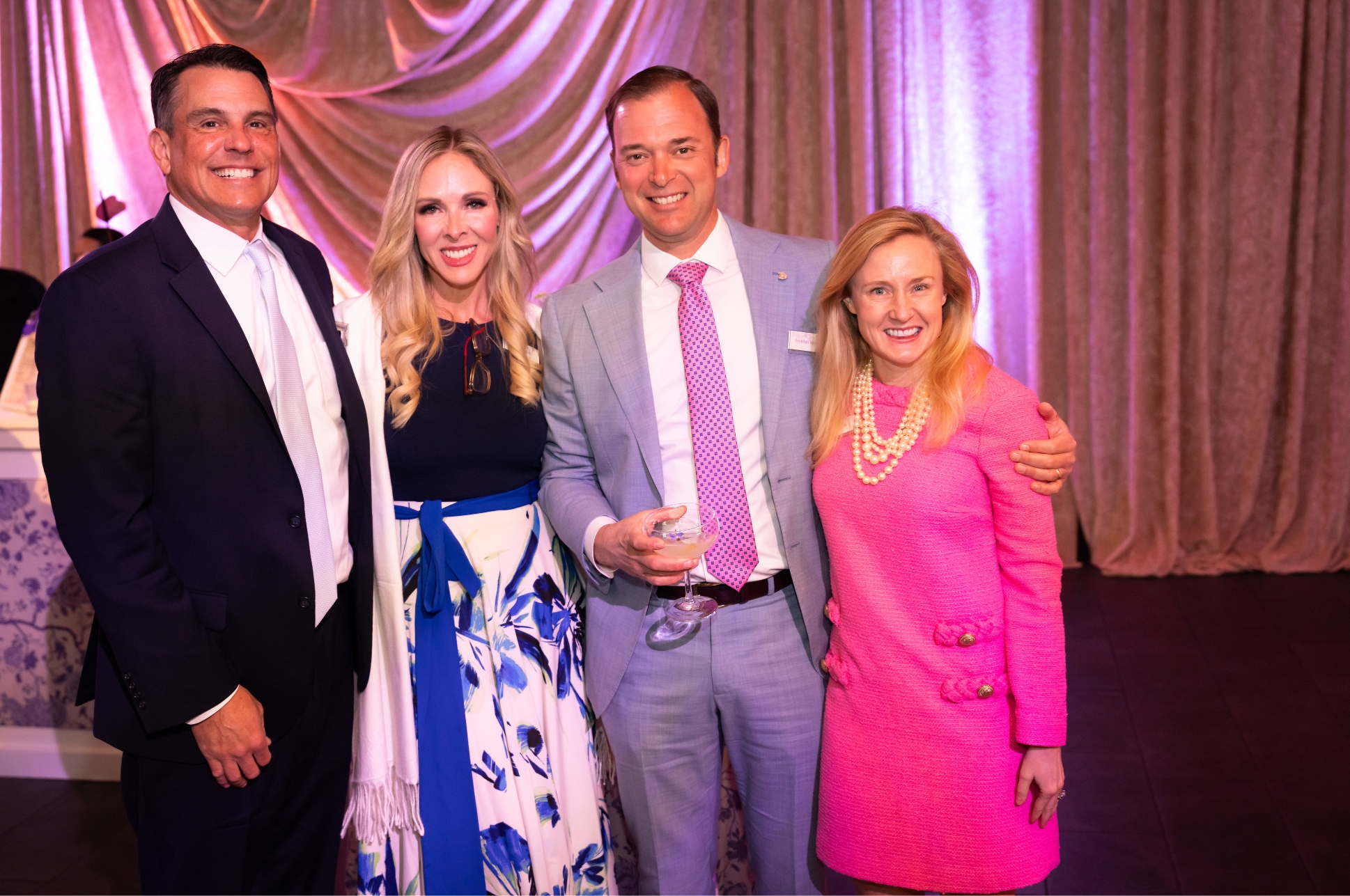 Gala_Corp Four guests standing together at the NEC Scholarship Gala.