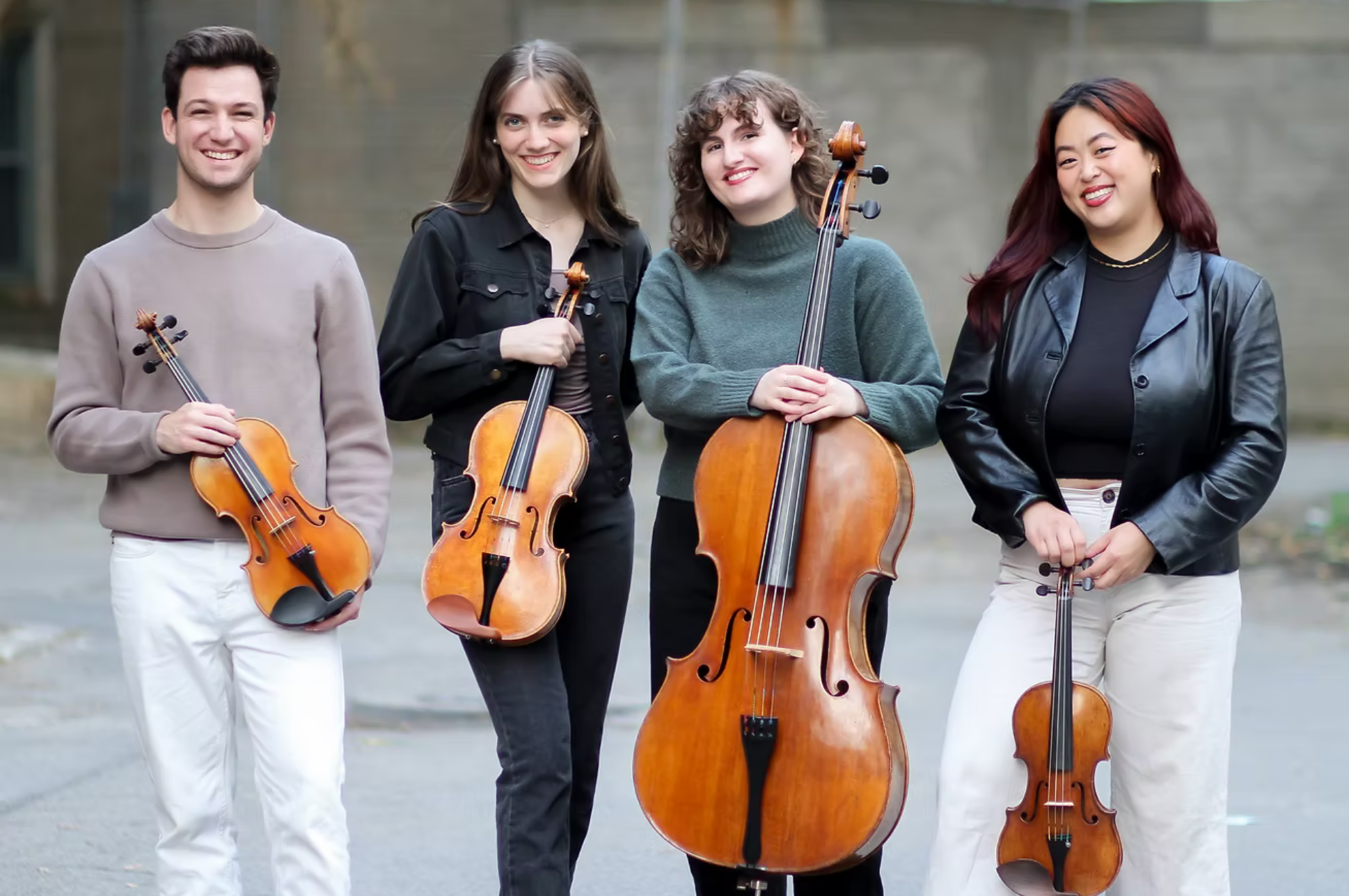  Katarina String Quartet holding their string instruments smiling. 