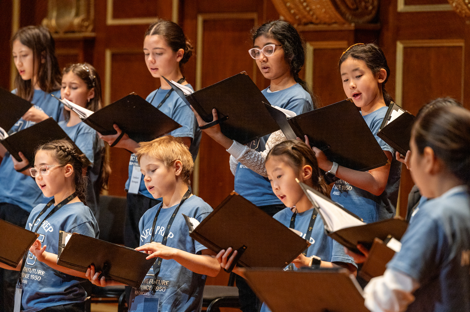A children's choir singing on the Jordan Hall Stage.