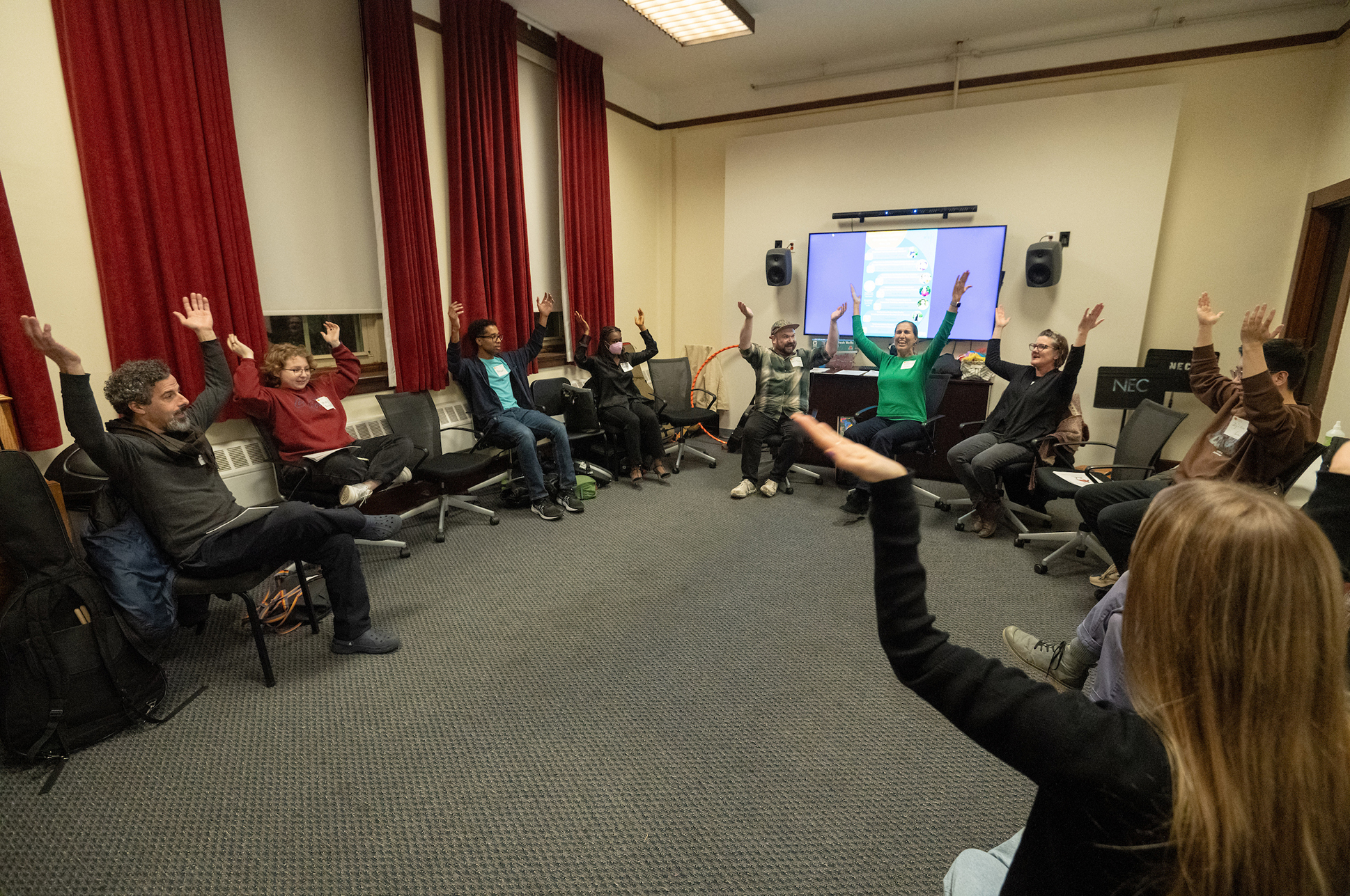 A group of teachers sitting in a circle participating in a workshop. A group of teachers sitting in a circle participating in a workshop.