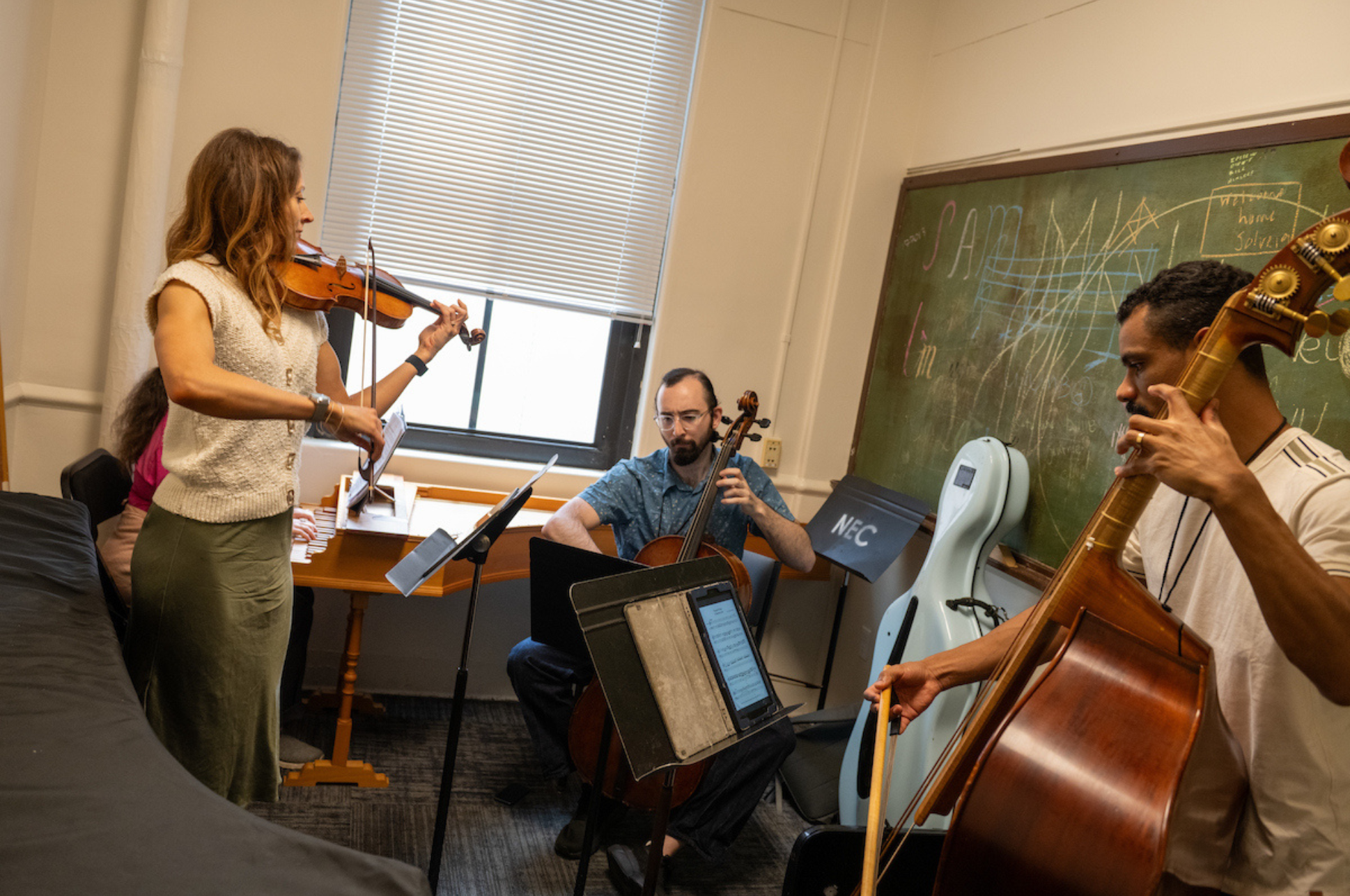 Students rehearsing in a practice room.